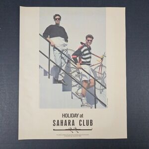 1987 Holiday Sahara Club Vintage Print Ad Carrying Bicycle Bike Down Stairs Shop